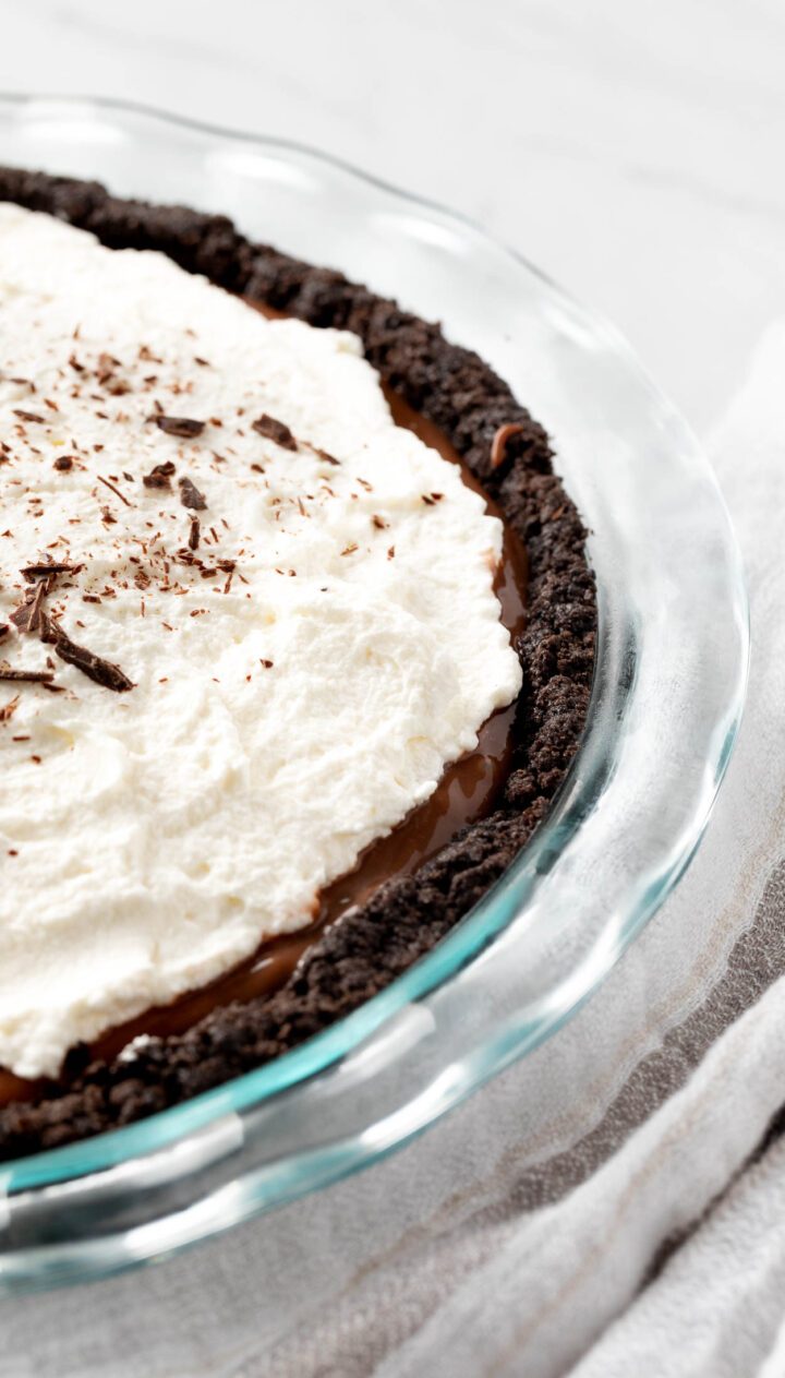 Homemade whipped cream on a pie with chocolate shavings. 