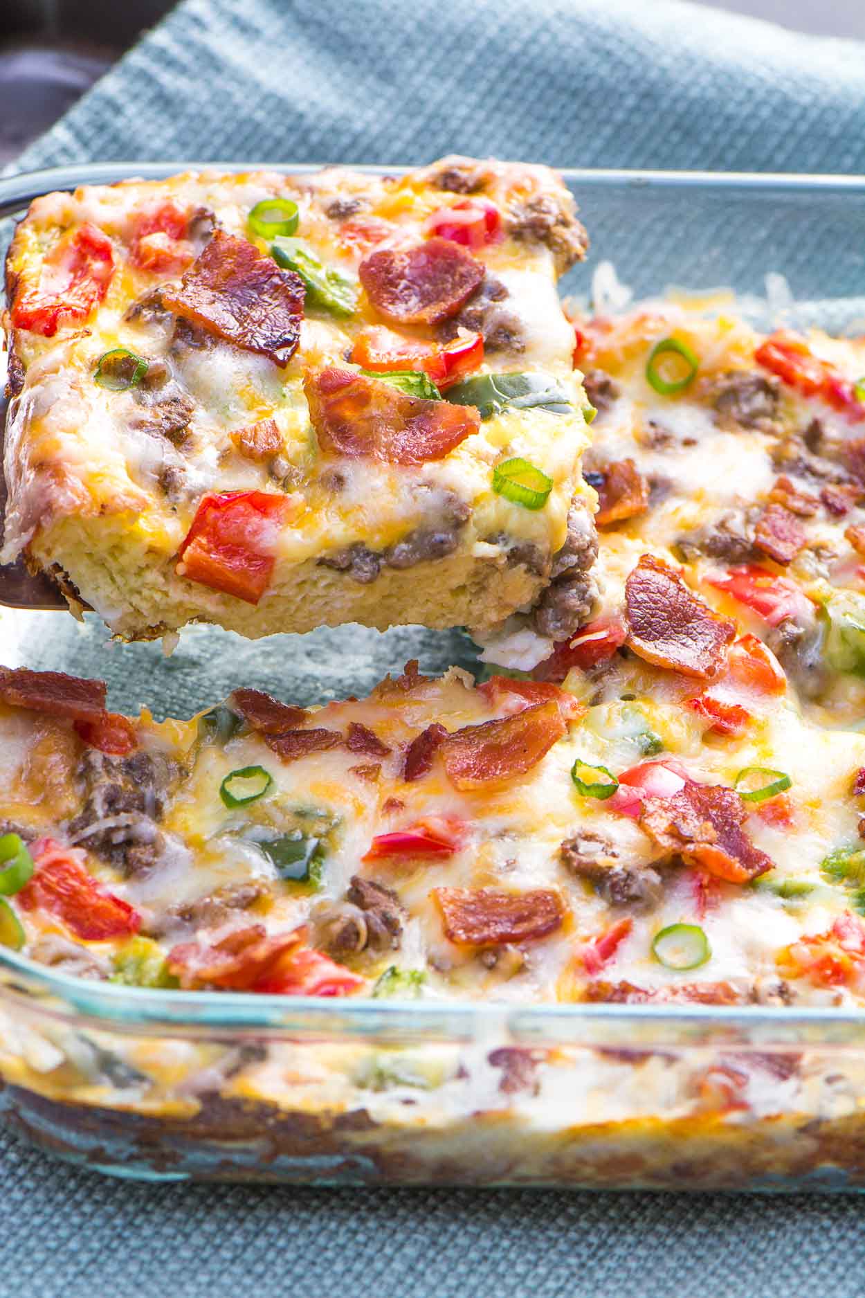 A healthy, fully loaded breakfast casserole topped with fresh veggies, meats and blends of cheeses. Breakfast is served! www.simplerevisions.com