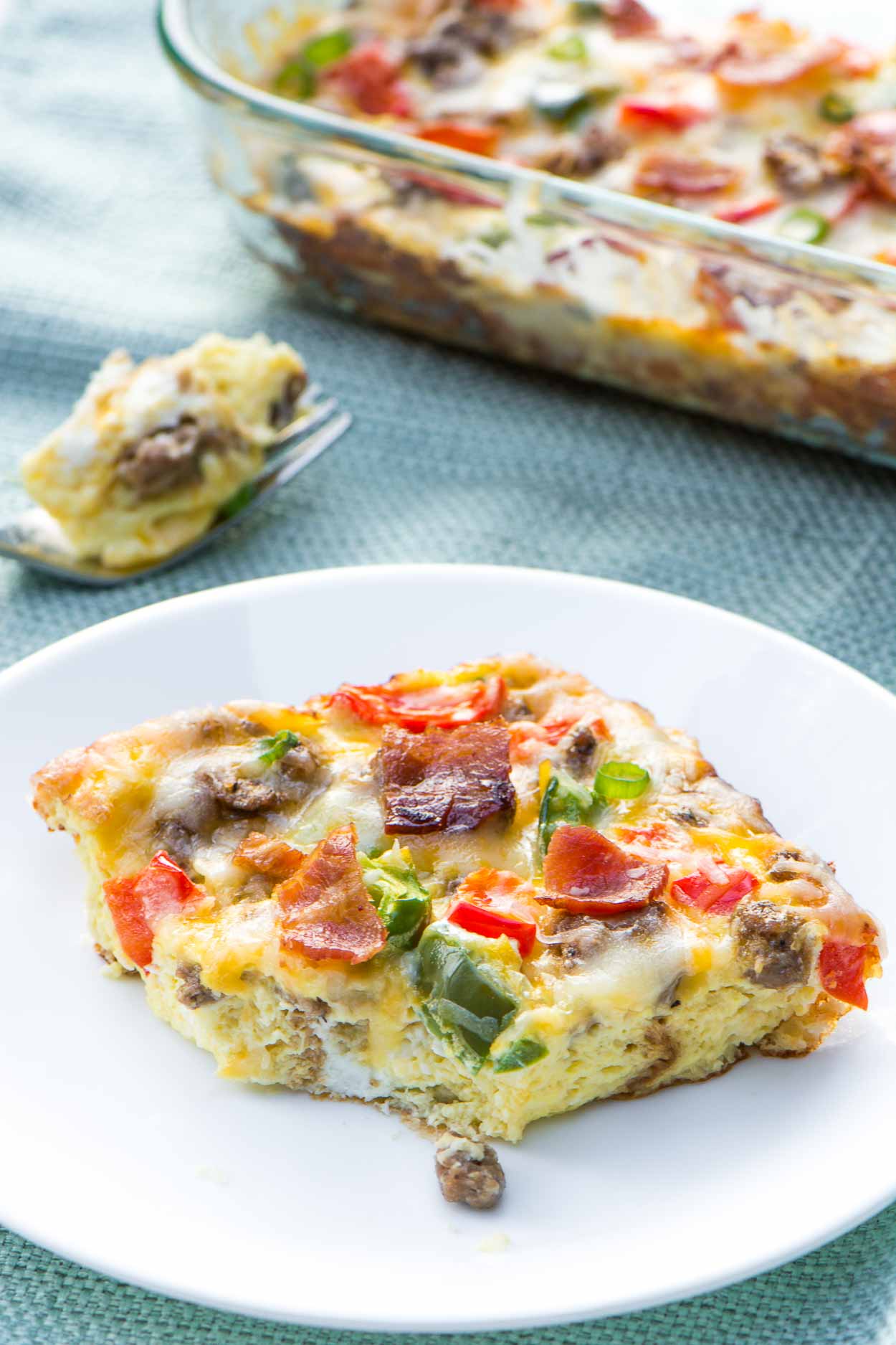 A healthy, fully loaded breakfast casserole topped with fresh veggies, meats and blends of cheeses. Breakfast is served! www.simplerevisions.com