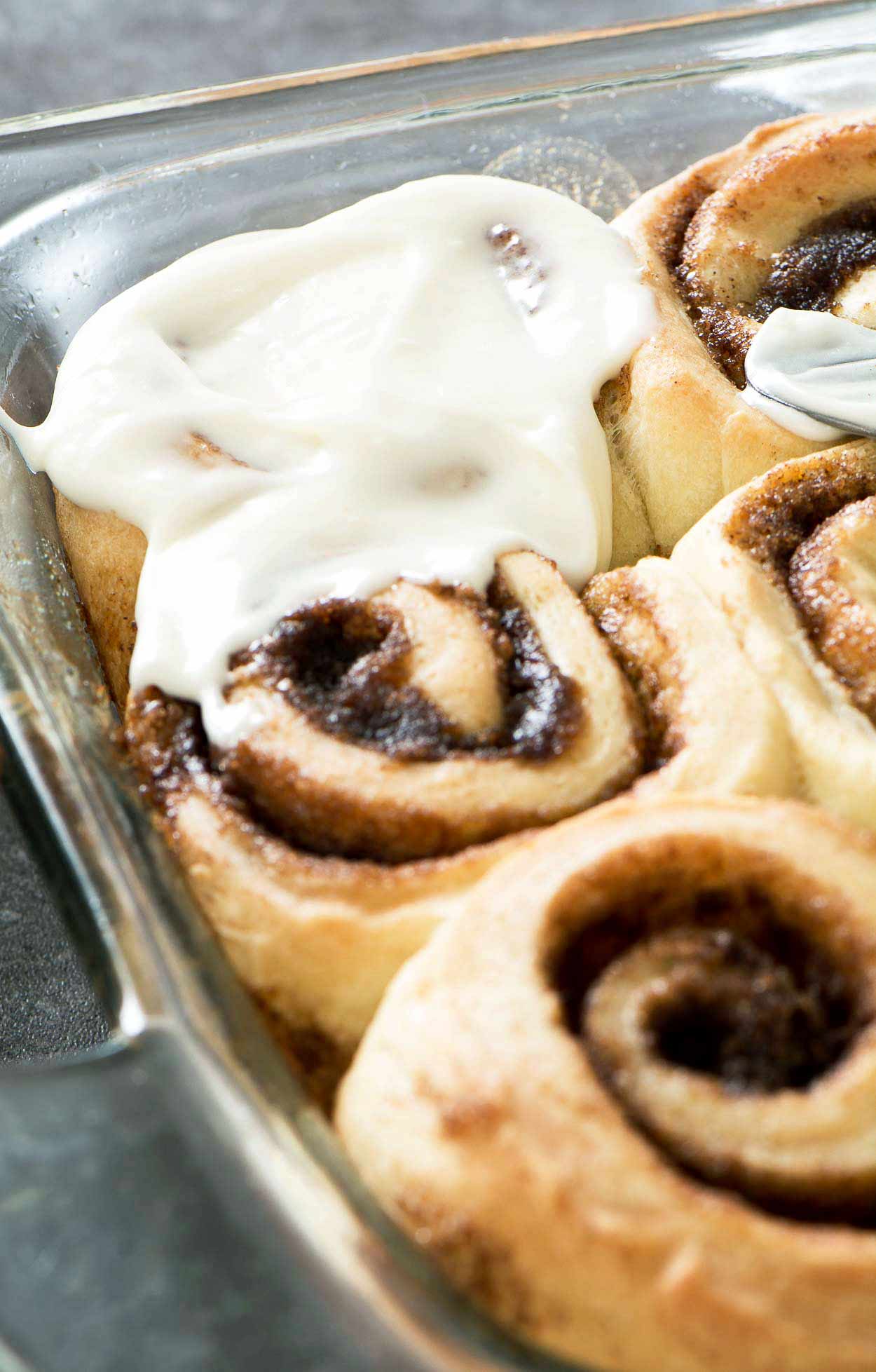 Made from scratch jumbo cinnamon rolls that are light and flaky. Filled with brown sugar, cinnamon and topped with a generous layer of cream cheese icing. | simplerevisions.com