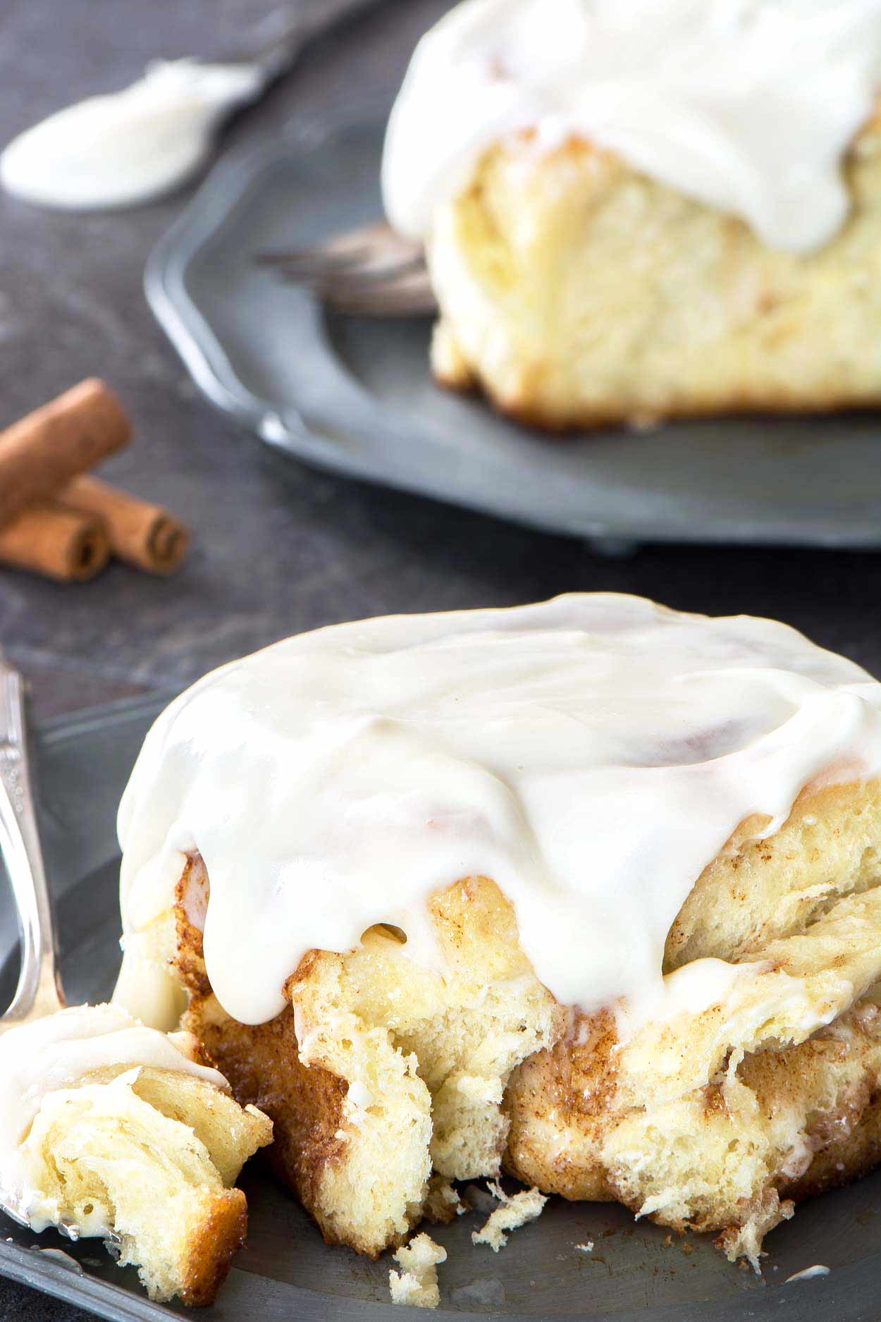 Made from scratch jumbo cinnamon rolls that are light and flaky. Filled with brown sugar, cinnamon and topped with a generous layer of cream cheese icing. | simplerevisions.com