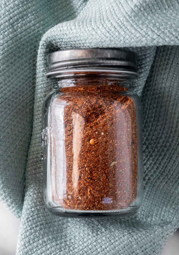 Homemade taco seasoning ingredients in a clear jar