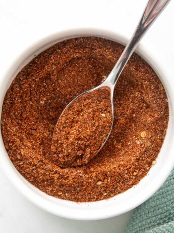 Homemade taco seasoning ingredients in a bowl with a spoon