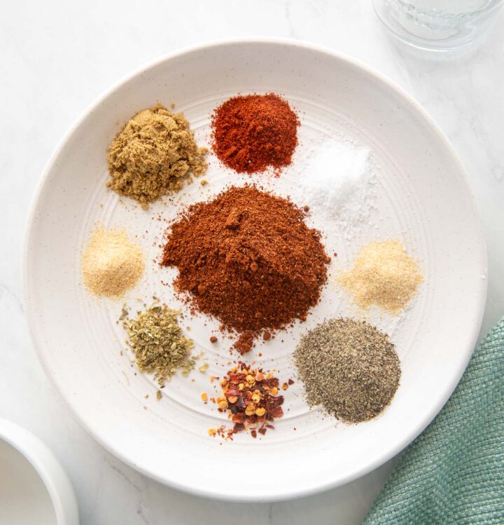 Homemade taco seasoning ingredients on a white plate.