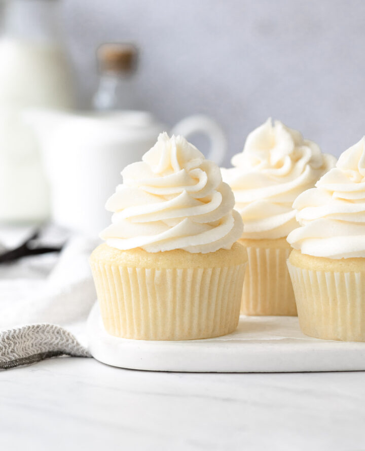 Vanilla Cupcakes with Buttercream Frosting on a marble plate.