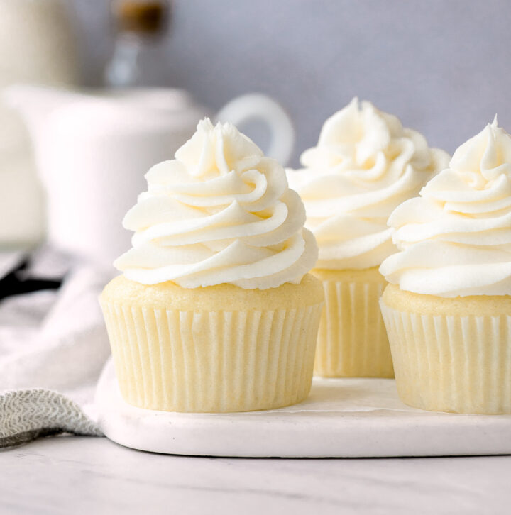 Vanilla Cupcakes with Buttercream Frosting on a marble plate.