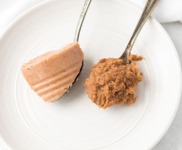 A scoop of refried beans on a spoon beside another spoonful of refried beans on a small white plate