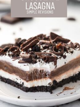 A slice of chocolate lasagna with a bite taken out of it on a small, white plate