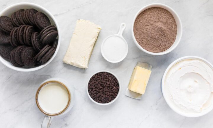 Oreo cookies, cream cheese, milk, mini chocolate chips, sugar, butter, pudding mix and Cool Whip in individual bowls.