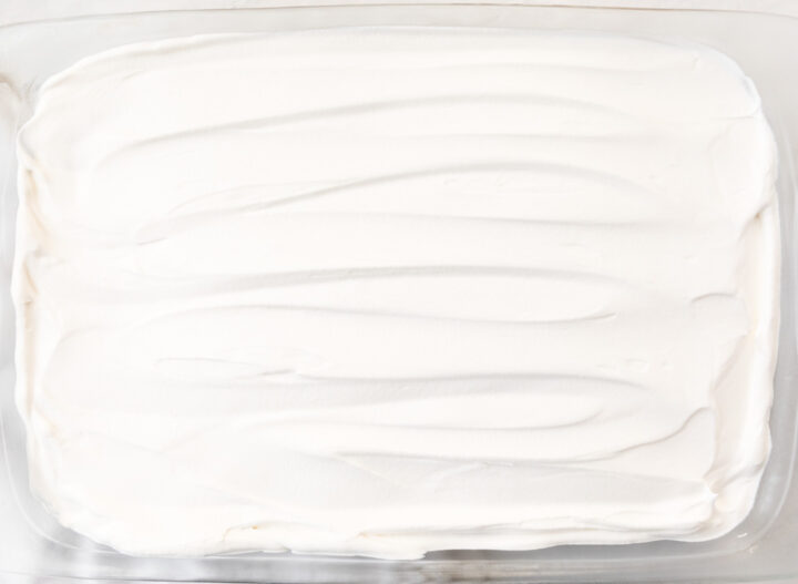 Cool Whip spread evenly onto the top  of a chocolate lasagna in a 9x13 baking dish.