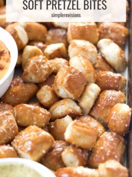 soft pretzel bites on a tray with nacho cheese sauce in a white bowl