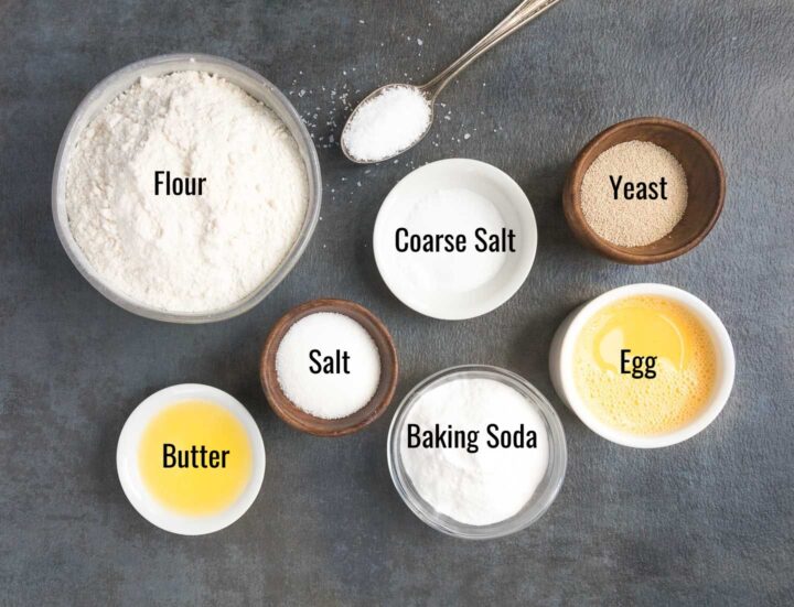 soft pretzel bites ingredients of sugar, salt, flour, yeast, baking soda, butter, egg in individual bowls