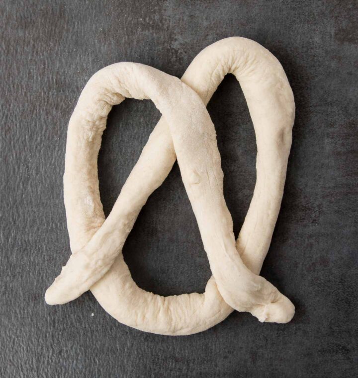 Pretzel dough formed into a pretzel shape.