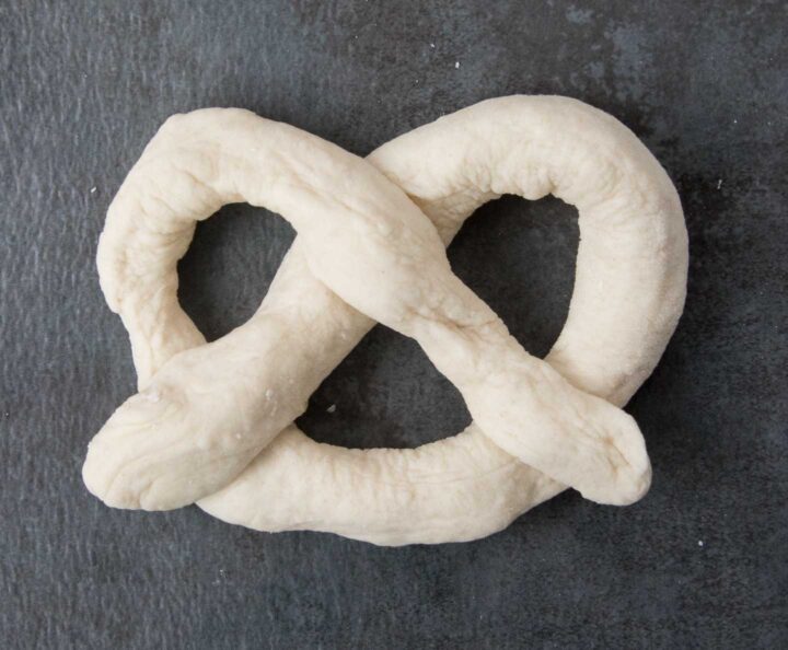 Pretzel dough formed into a pretzel shape.