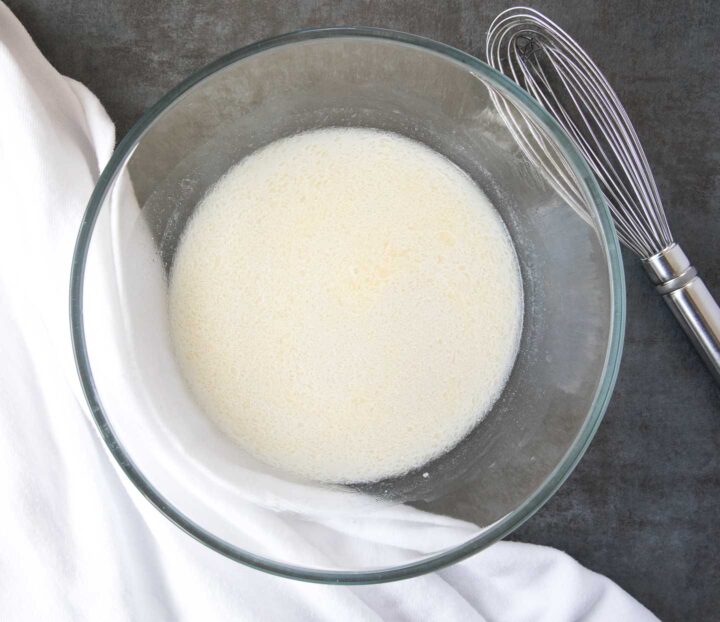 Yeast, water and sugar dissolved in a bowl.